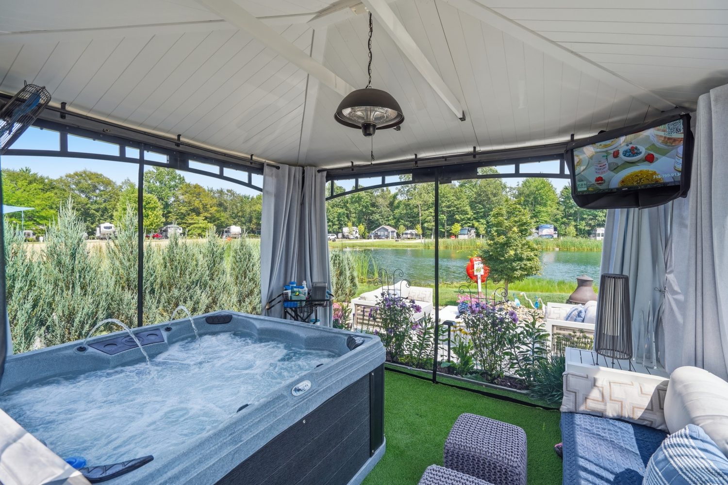 Hot tub inside a screened enclosure with lake views